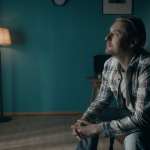 a man sat alone looking unhappy