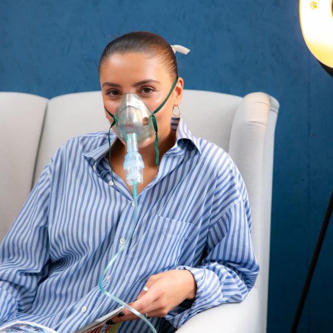 HybO2 client sat receiving normobaric oxygen therapy via concentrator