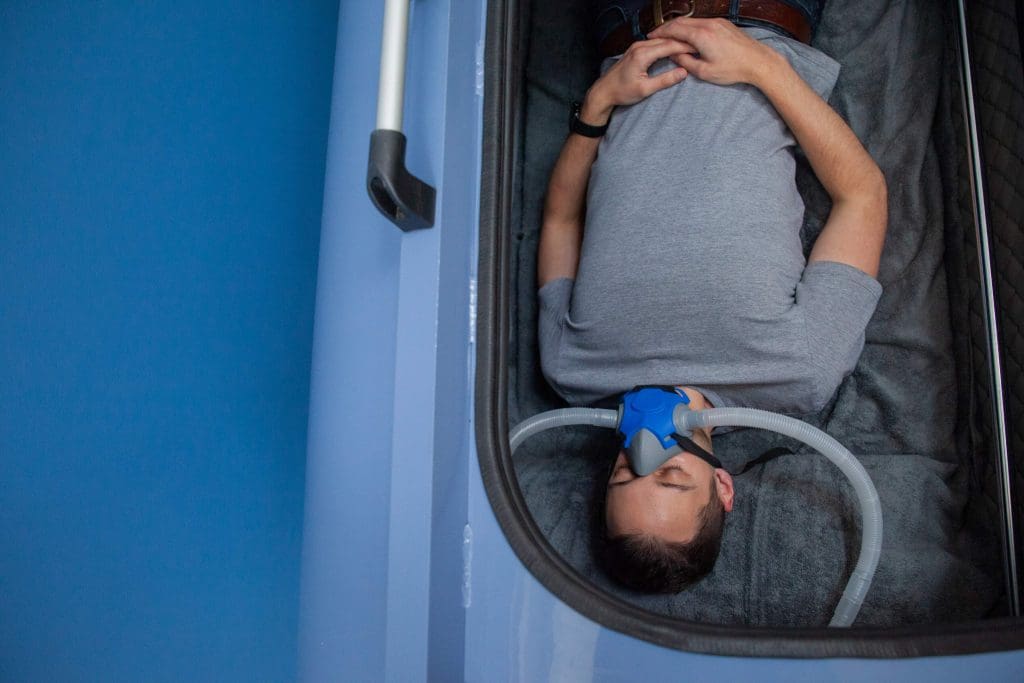 A client in a hyperbaric oxygen chamber to help improve his mental health