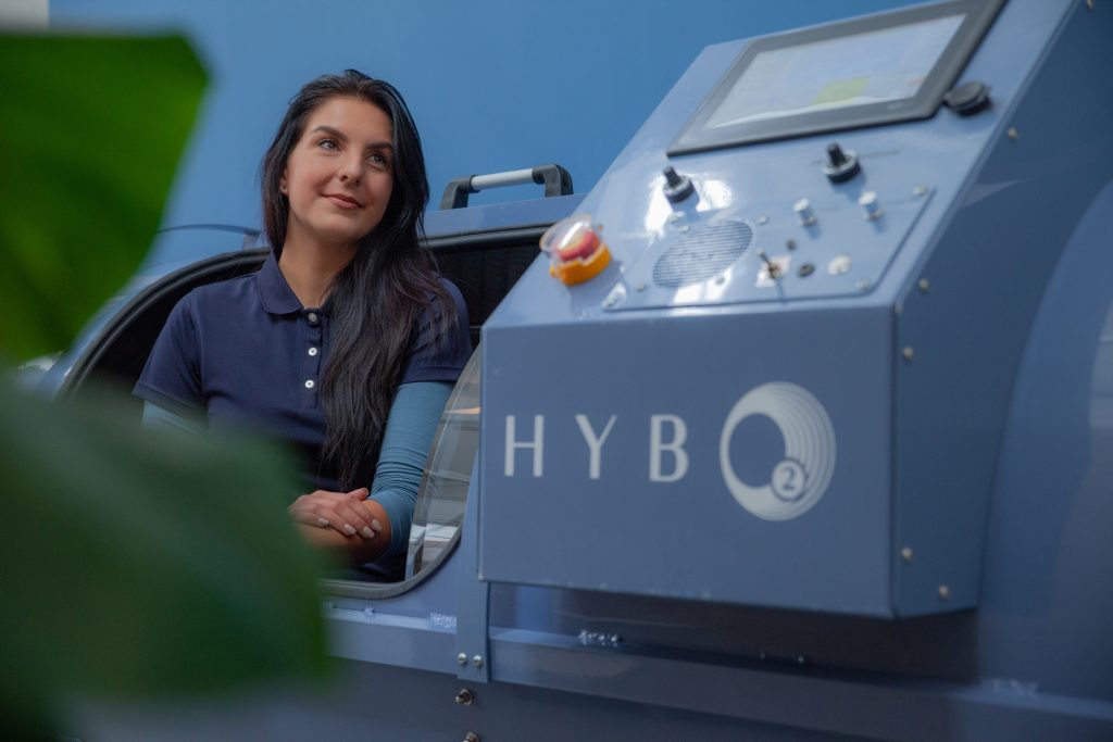 A HybO2 client sitting inside one of the hyperbaric oxygen chambers